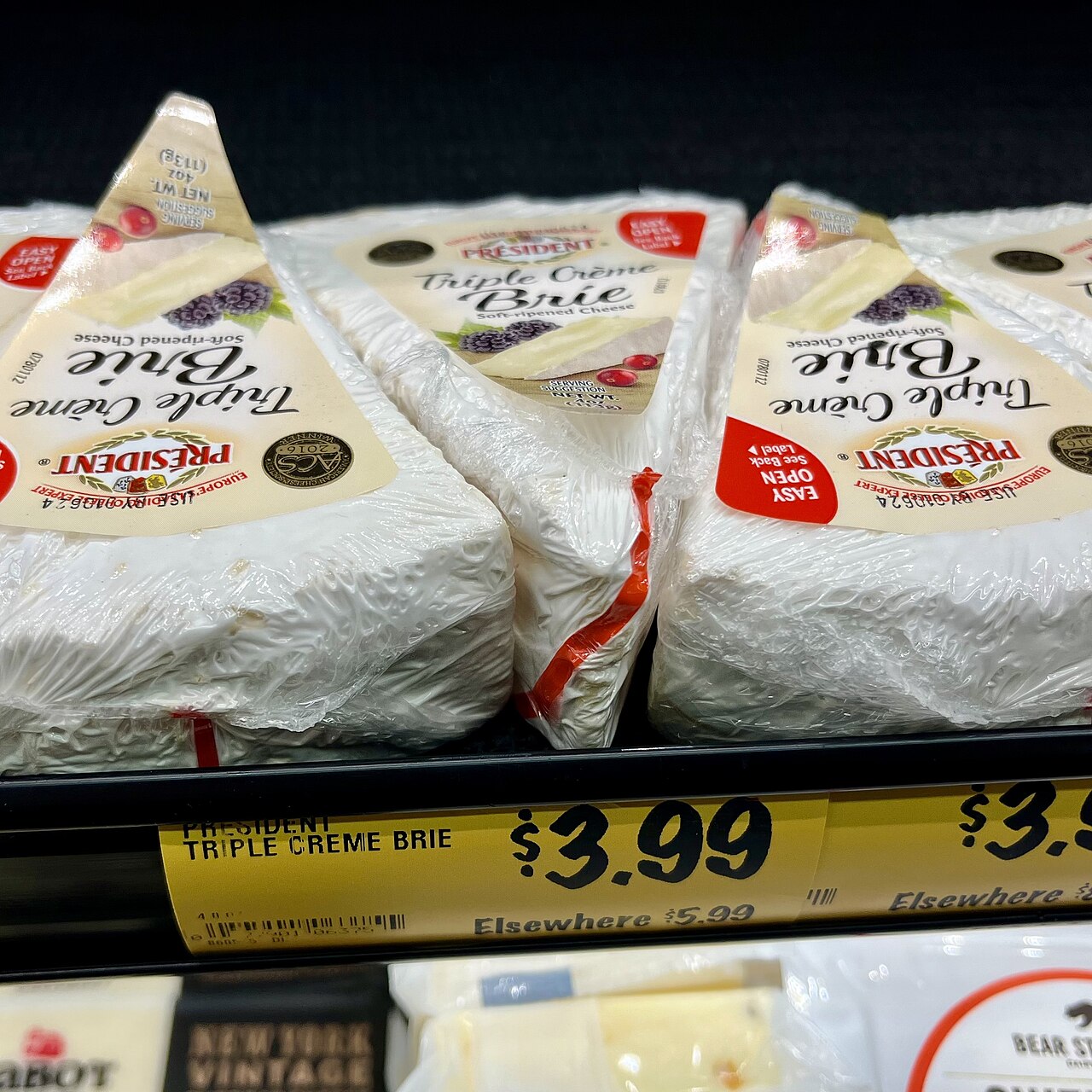 Brie wheels ripening on a shelf